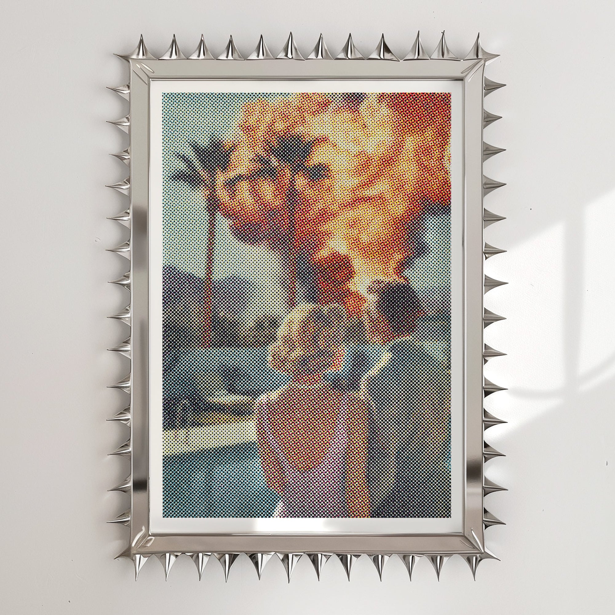 Framed artwork of a couple by palm trees with a fiery background